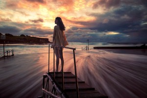 Woman assessing into a ghostly sunset