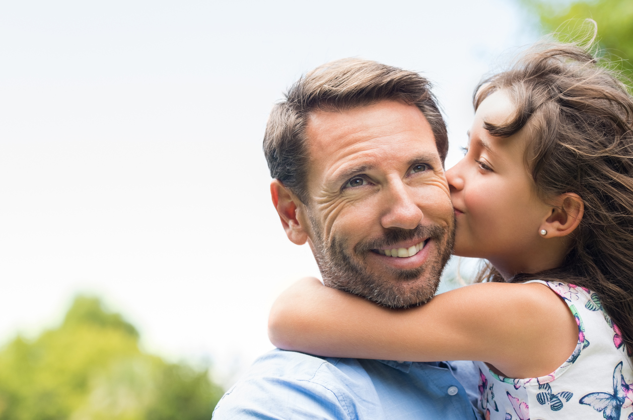 Picture of girl kissing father, enjoying the moment